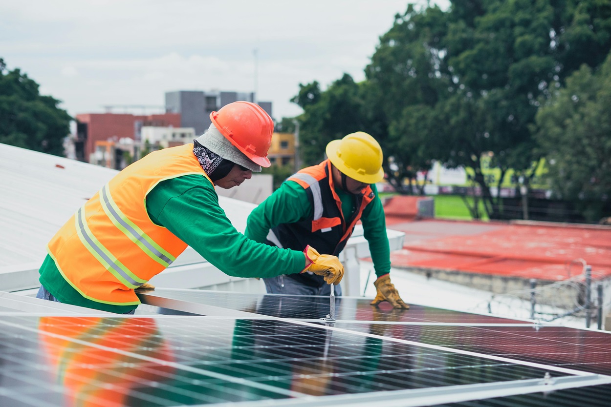 Field technicians installing solar panel 